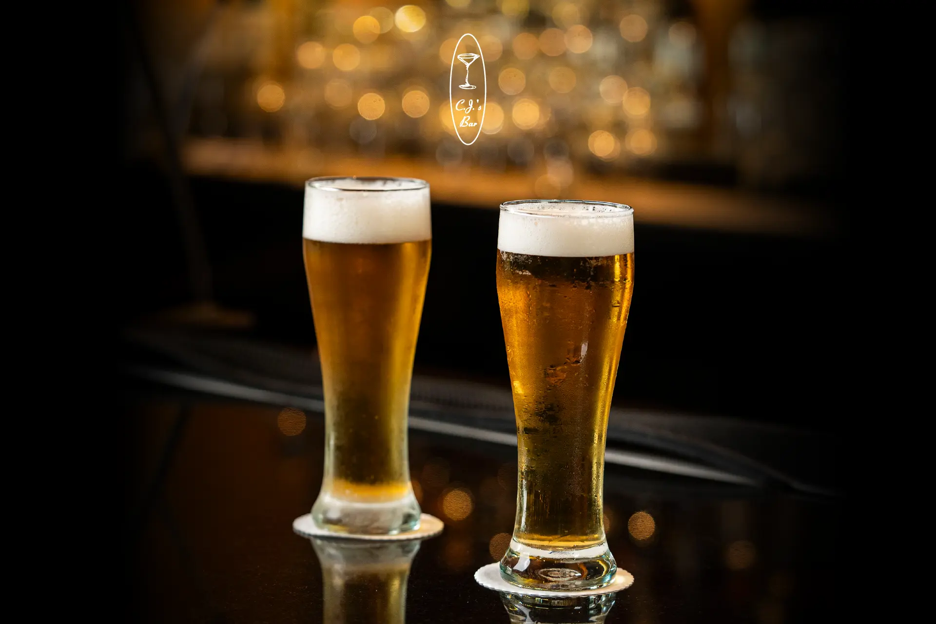 Two glasses of draught beer on a bar counter, promoting Octobeer Fest at CJ's Bar, Hotel Mulia Senayan, Jakarta.
