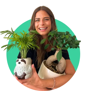 Woman smiling with plants in her hand