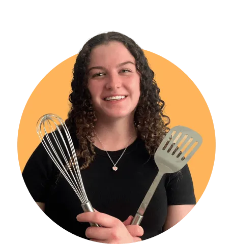 Woman with cooking spoons smiling