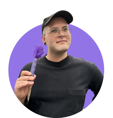 Man smiling holding duster