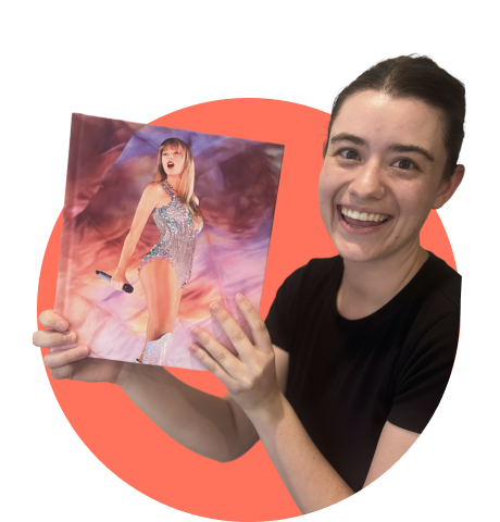 Woman smiling holding a Taylor Swift album