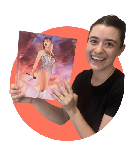 Woman smiling holding a Taylor Swift album