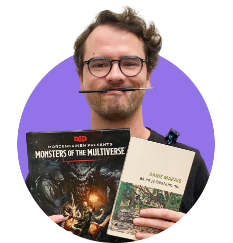 man holding books and paint brush