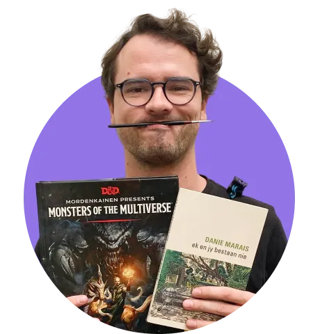 man holding books and paint brush