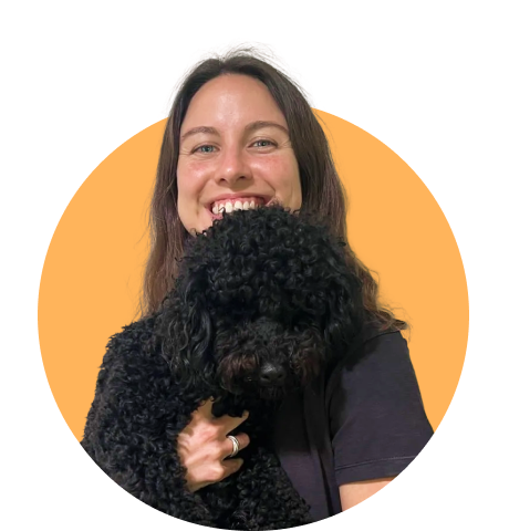 Lady smiling holding dog in her hand