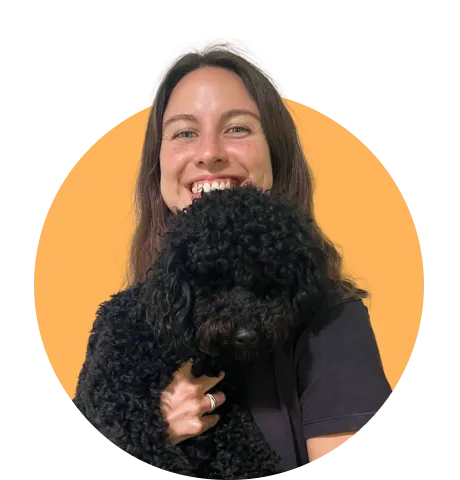 Lady smiling holding dog in her hand