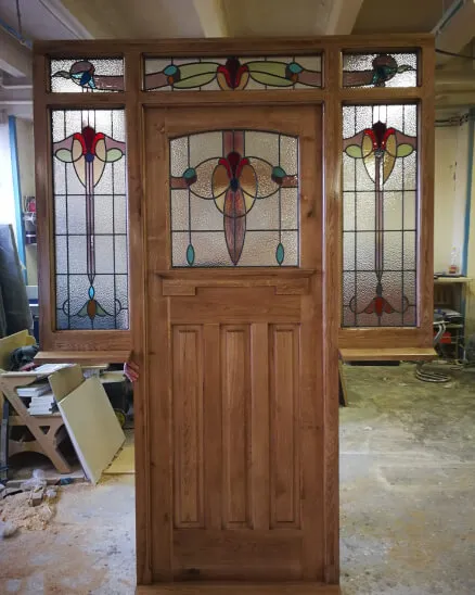 a 1920s period front door with side panels with stained glass