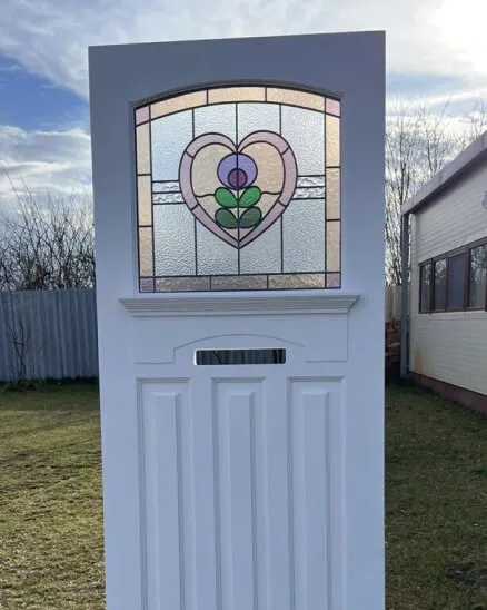 1930s style hardwood front door with simple stained glass