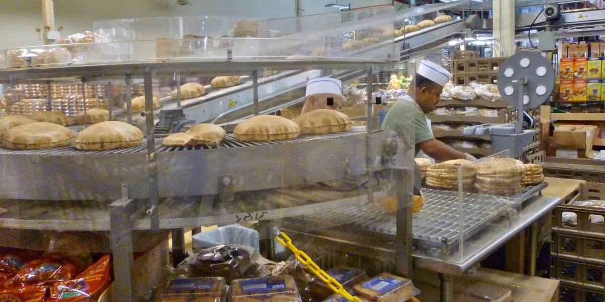 Professional baker preparing baked goods in a commercial kitchen
