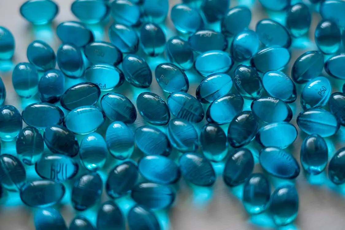 Free Blue Gel Capsules on Table Stock Photo