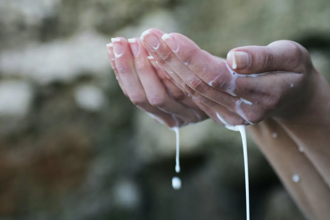 Free Person's Hands Covered in White Liquid Stock Photo