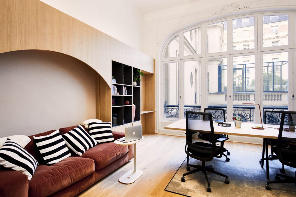 A warm workspace, with sofa and desks