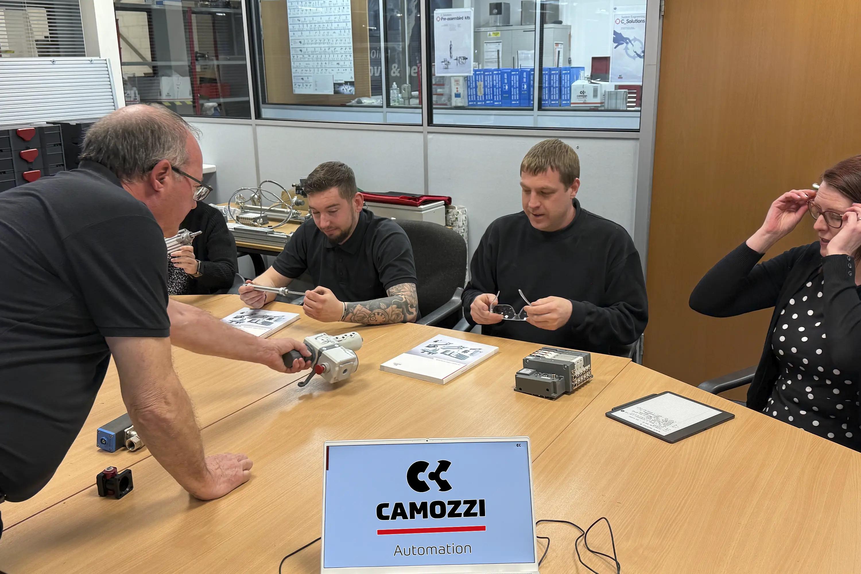 Industry expert Steve Partington demonstrating electro-pneumatic components to a group of delegates during a classroom theory session at the Camozzi Automation UK training centre.