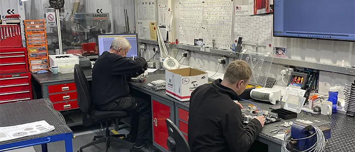 Camozzi UK engineers assembling bespoke pneumatic systems at their workbenches inside the Nuneaton Automation Centre workshop.