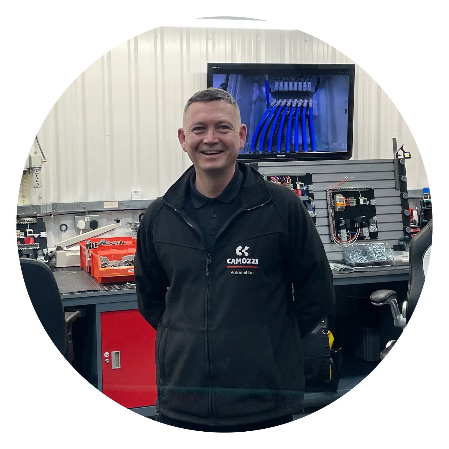 Mark Clifton, Head of System Builds and Assembly at Camozzi Automation UK, smiling while standing in the UK Automation Centre workshop.