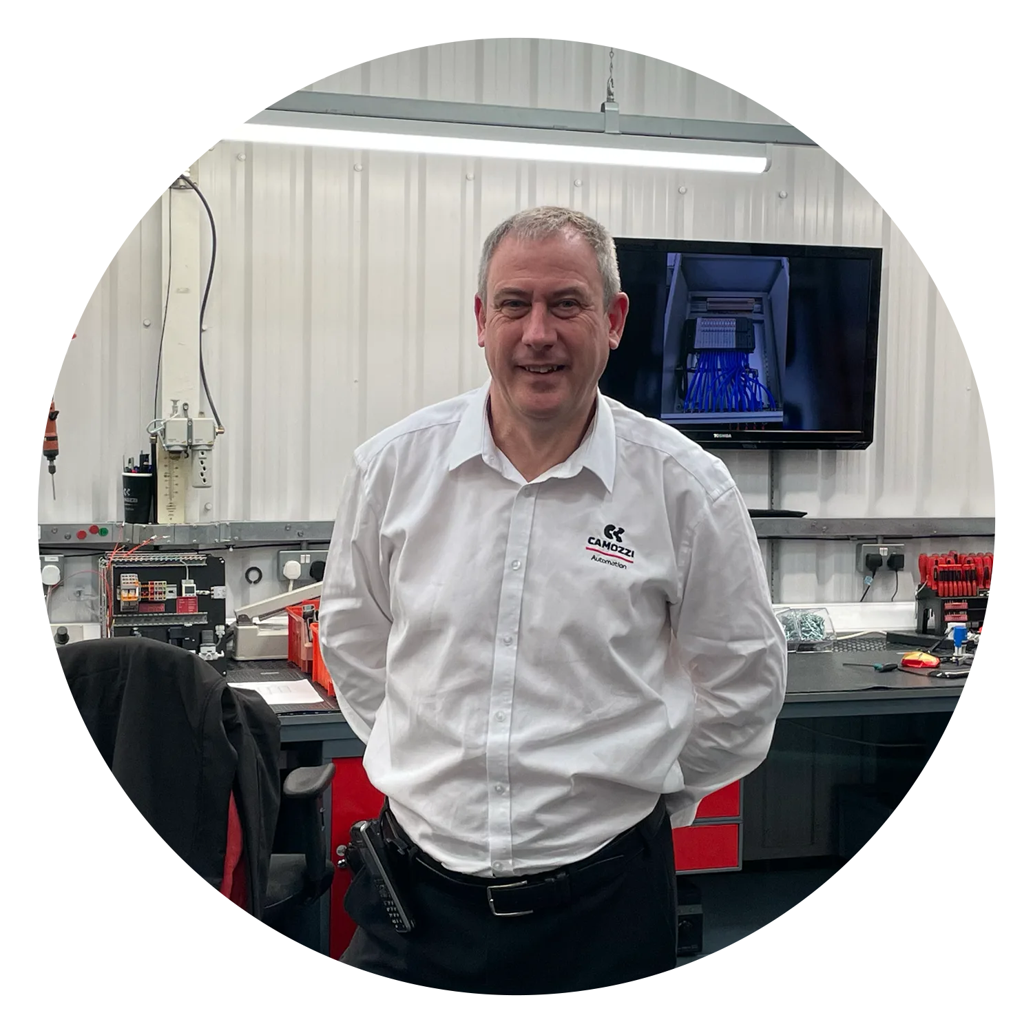 Mark Thompson, Applications Engineer at Camozzi Automation UK, smiling while standing in the UK Automation Centre workshop.
