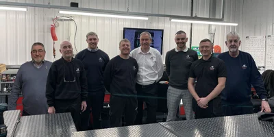 A group photo of the Camozzi UK Automation Centre engineering and assembly team standing together inside the workshop.