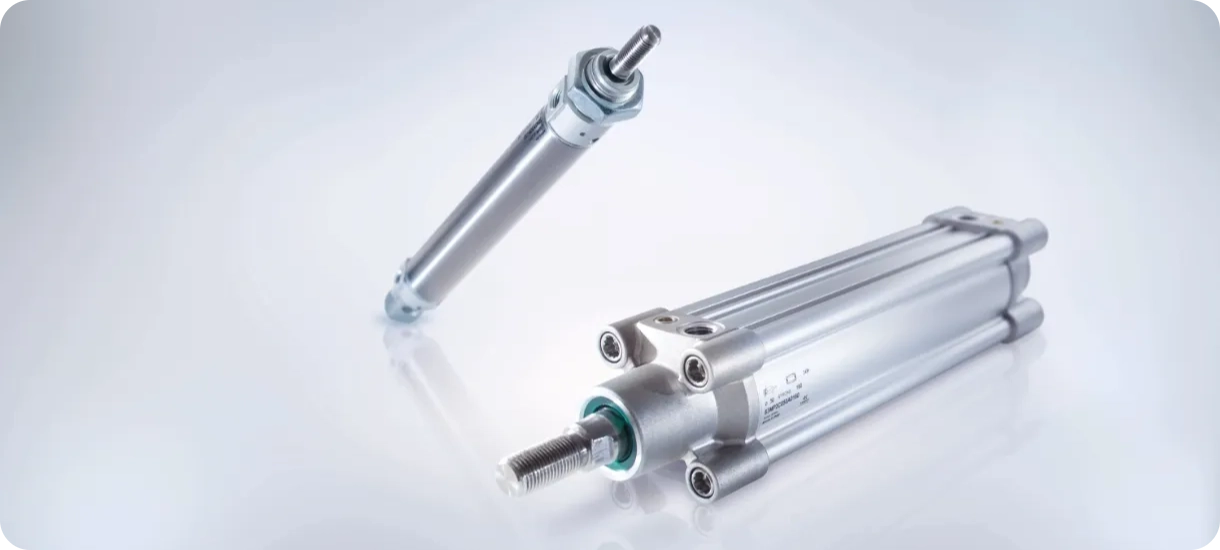 Two Camozzi pneumatic cylinders, demonstrating the variety of bore sizes, stroke lengths, and profile types available for different automation applications.