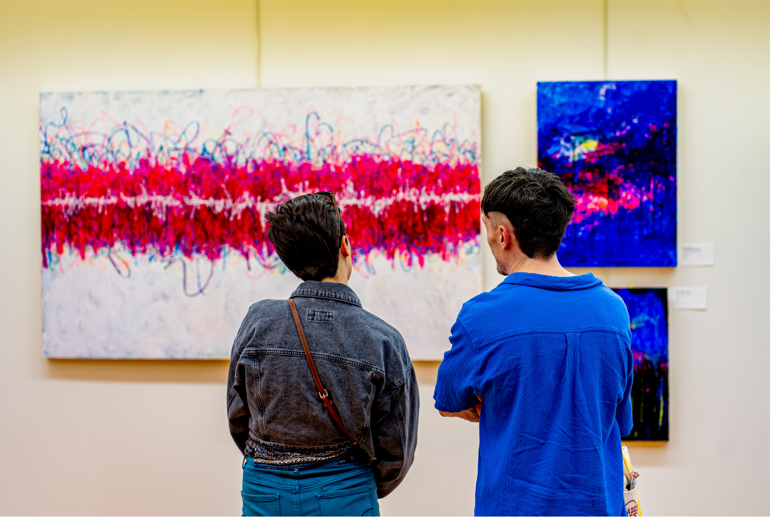 Guests share a conversation during a art show at Atithi Studios art gallery & exhibit hall.