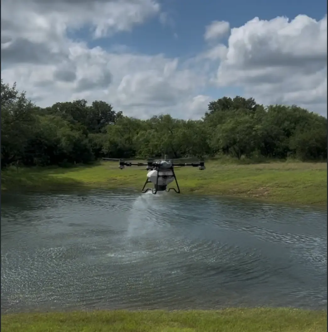 Drone spreading sealant over a pond