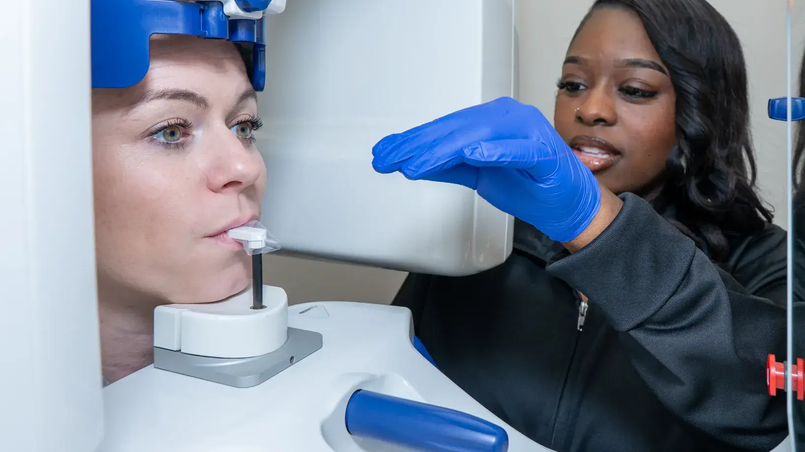 Team member and patient getting X-rays