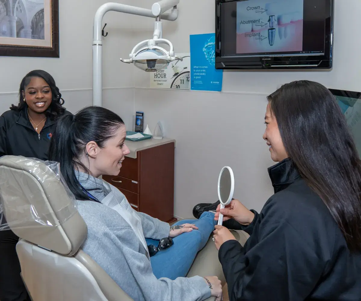 Dr. Phung showing mirror to patient