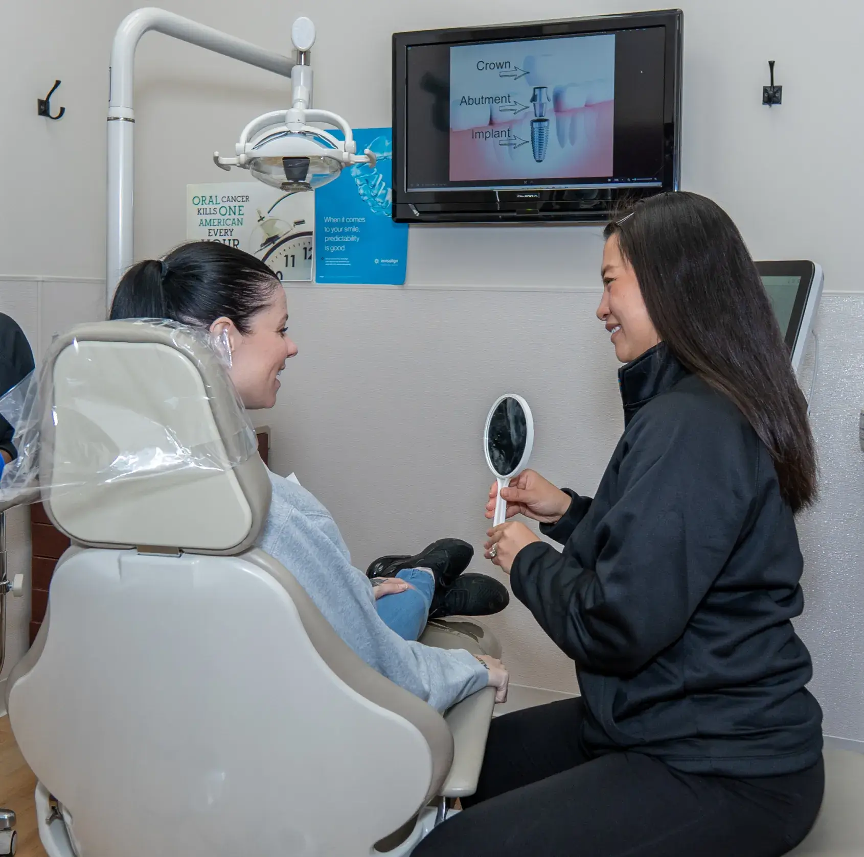 Dr. Phung showing mirror to patient