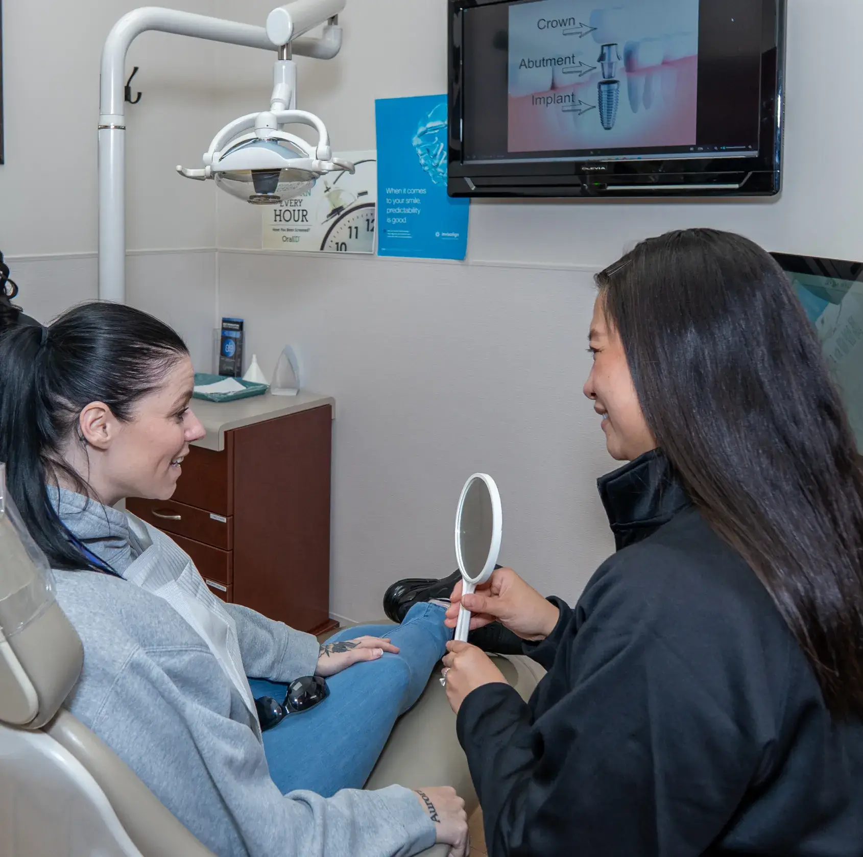 Dr. Phung showing the mirror to the patient