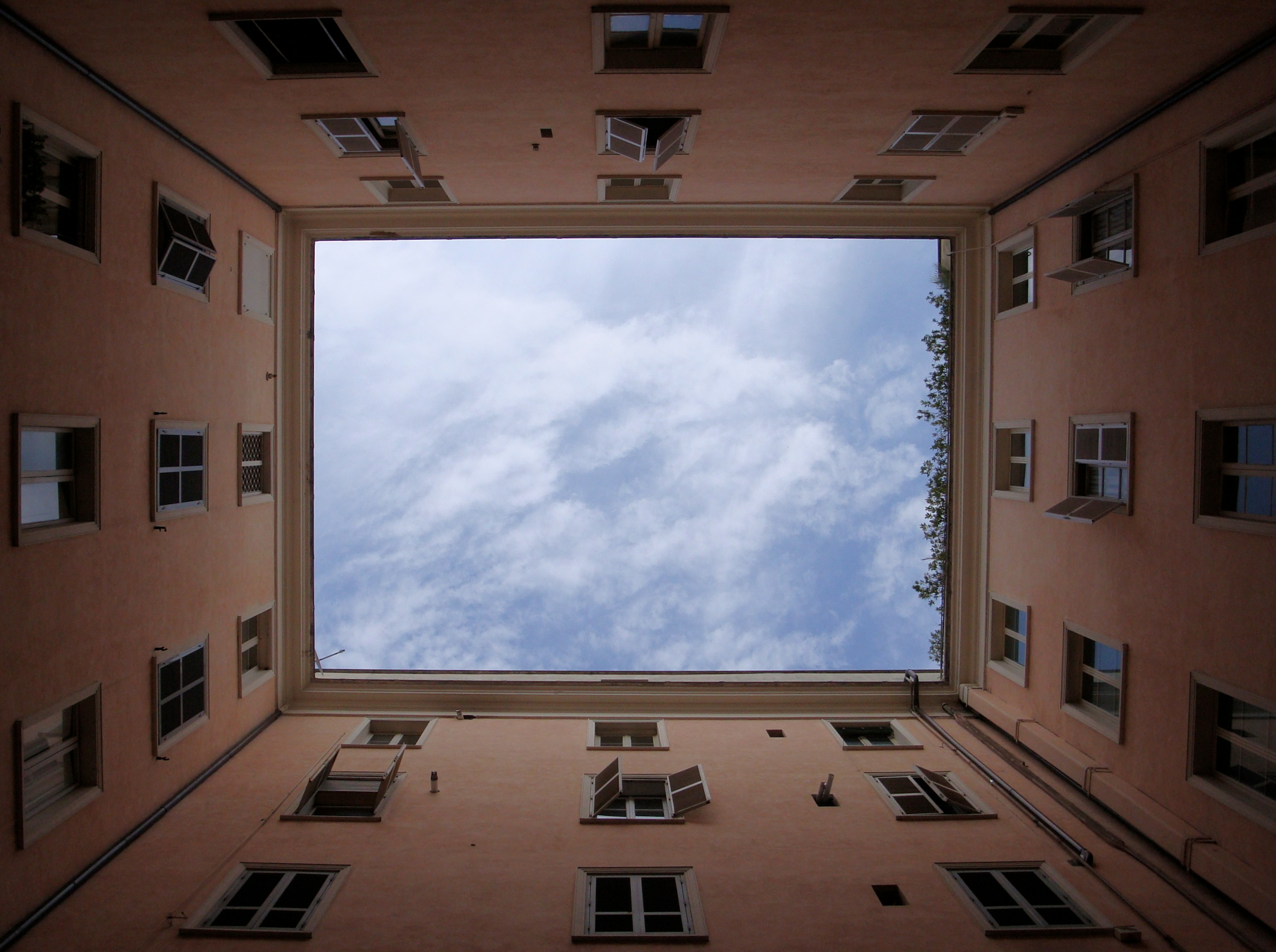Looking up at the sky while surrounded by buildings.