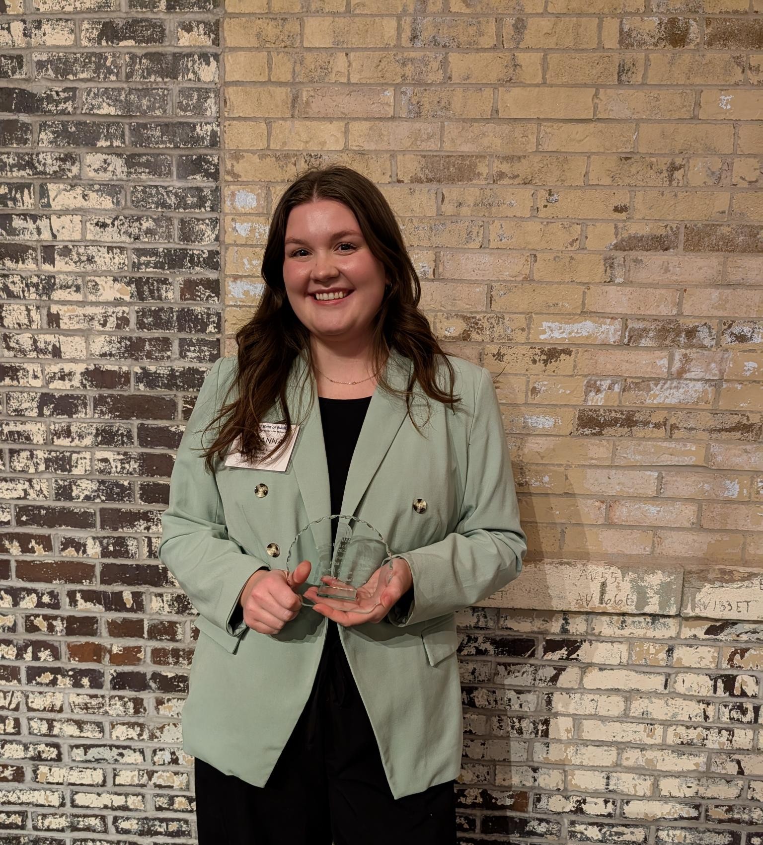 Suzanna Viau of Padilla holding a NAMA award