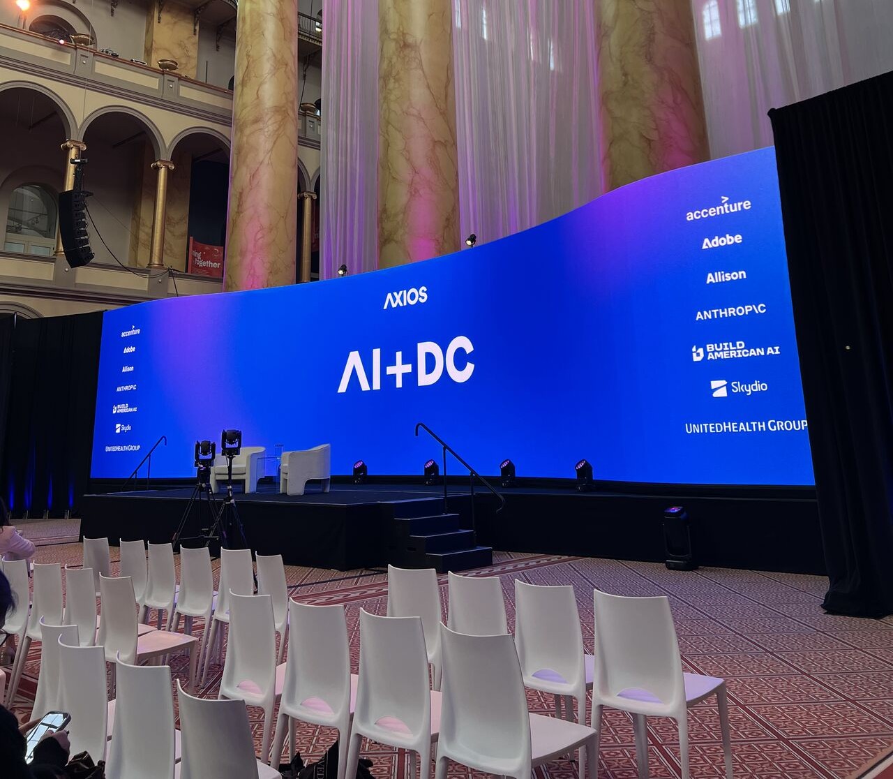 A screen at the Axios summit that says AI + DC