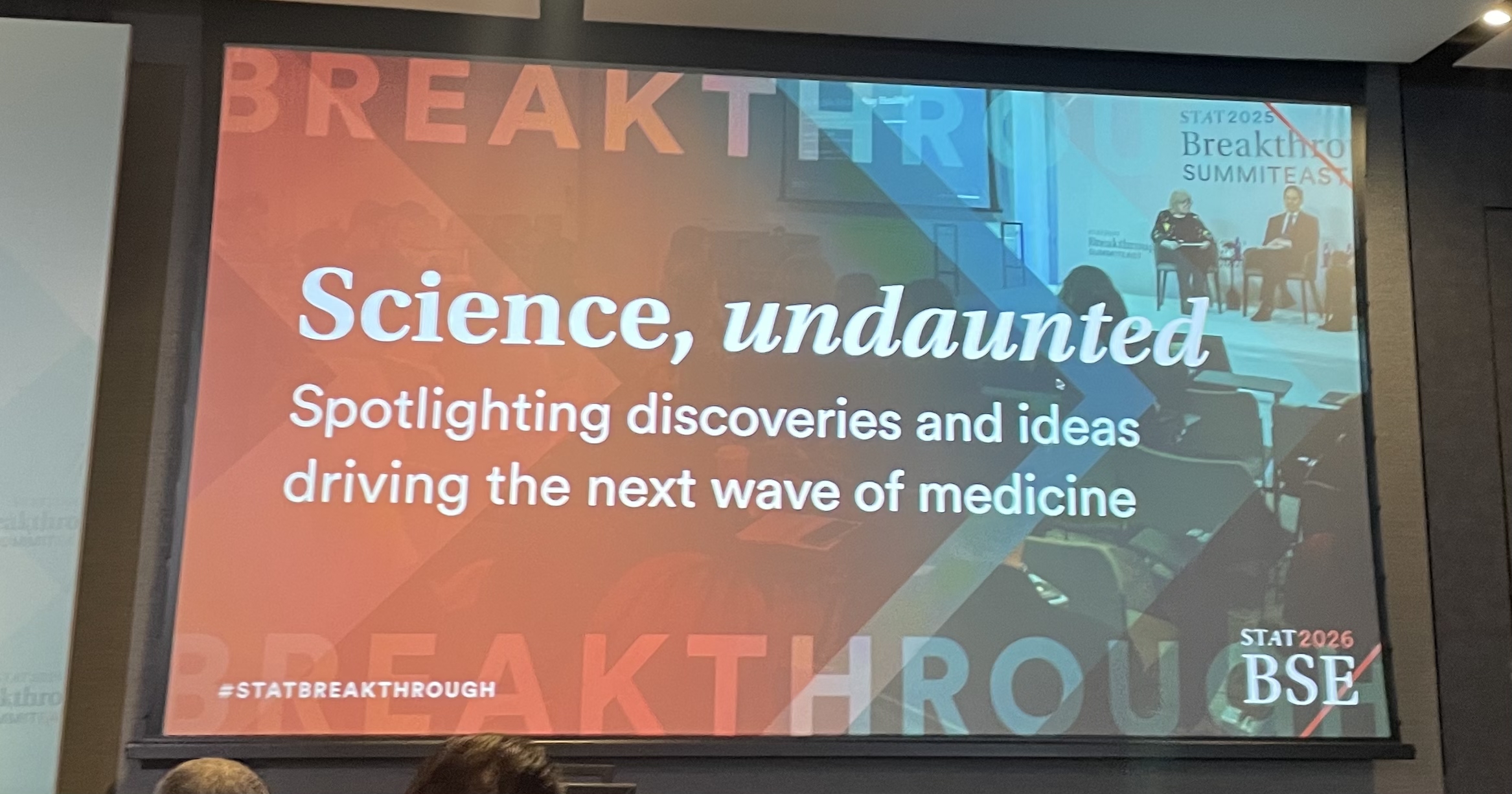 A monitor at the STAT conference with the name of a session.