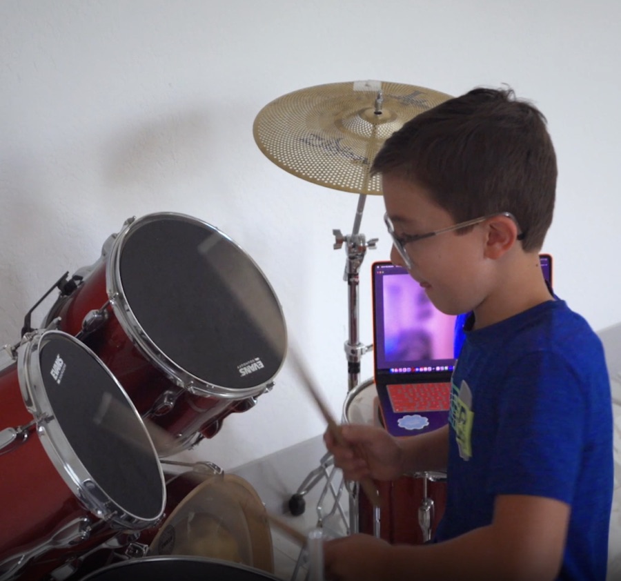 A Novatio student playing drums in a club
