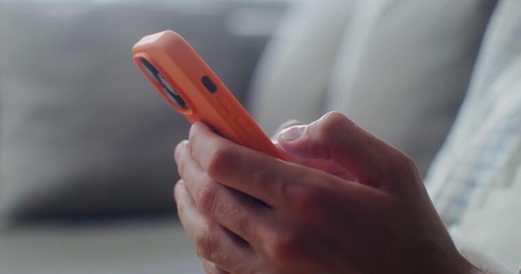 Person interacting with a phone representing digital nudges