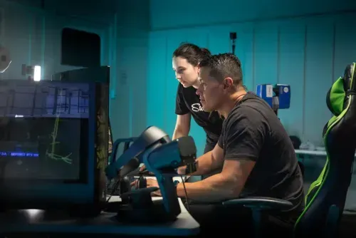 a man and a woman sitting in front of a computer