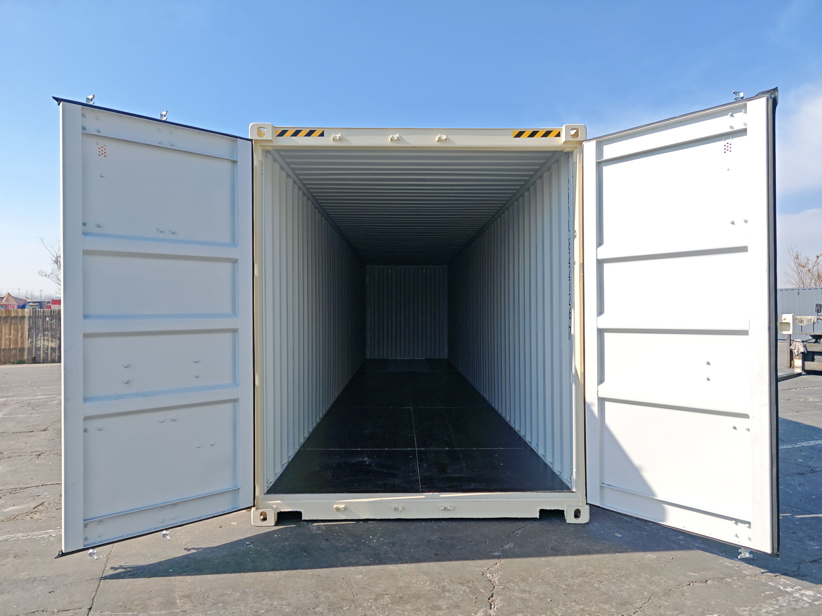 New light yellow shipping containers stacked onto of each other