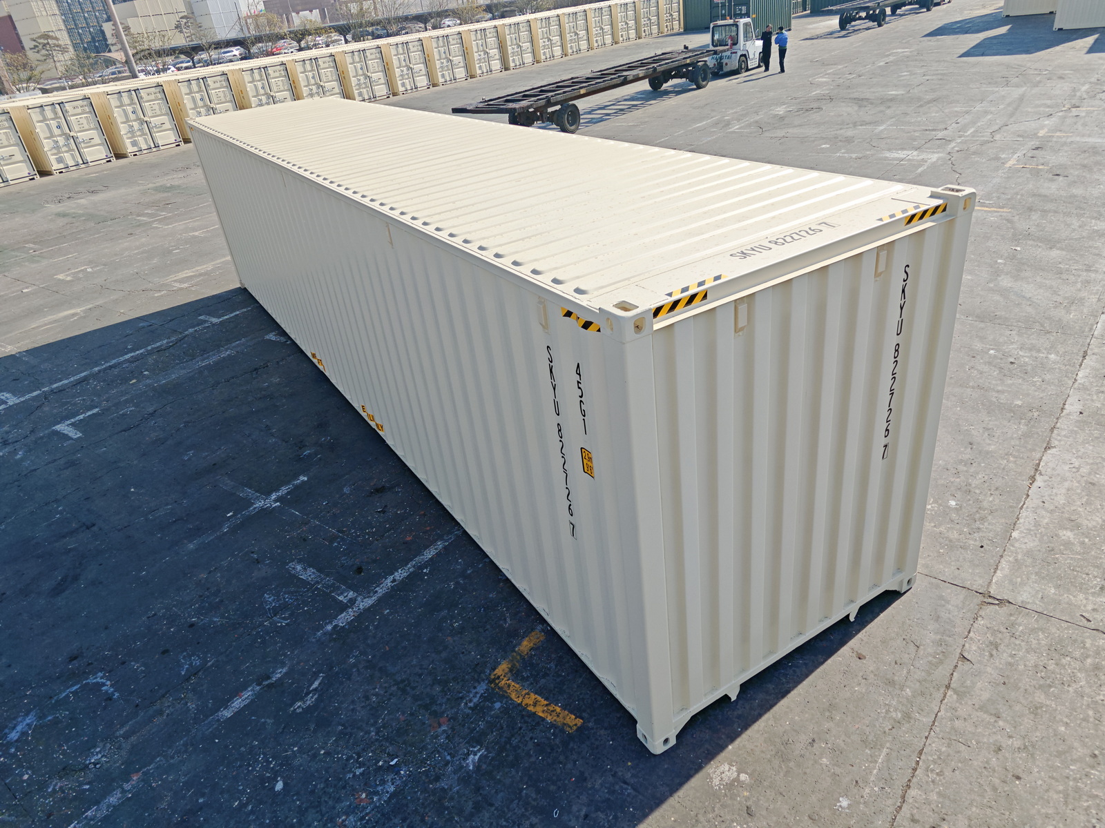 The inside of a large shipping container. Showing a wooden floor and clean white panels