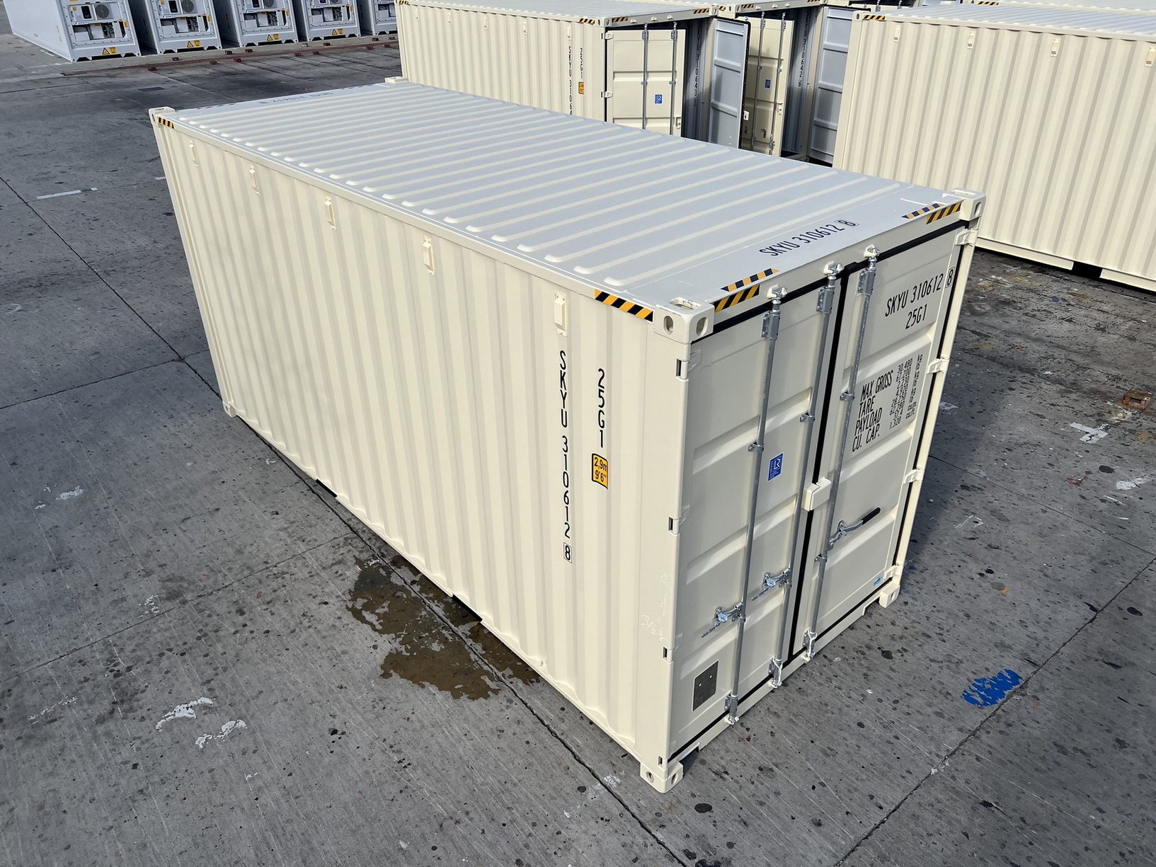 A creamy yellow shipping container with a blue sky background