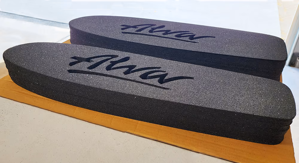 Two stacks of laser-cut grip tape, made for the Alva Skate company's skateboards 