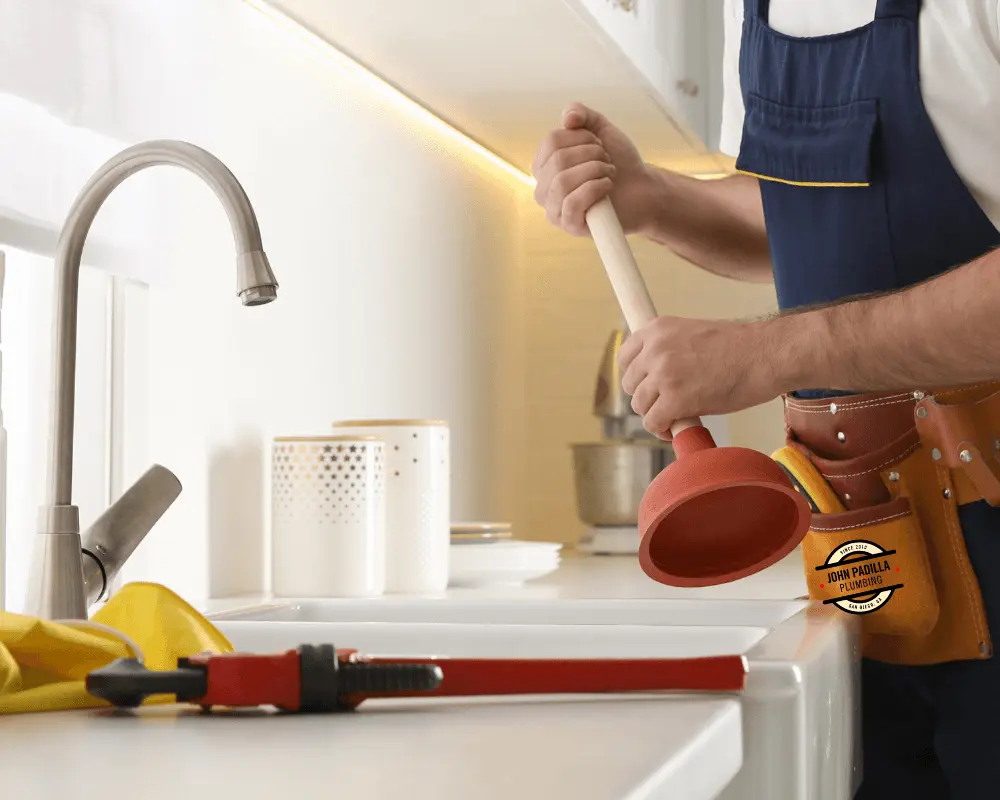 plumber unclogging a drain