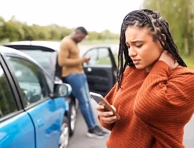 Female Motorist Involved In Car Accident Calling Insurance Company Or Recovery Service