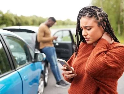 Female Motorist Involved In Car Accident Calling Insurance Company Or Recovery Service