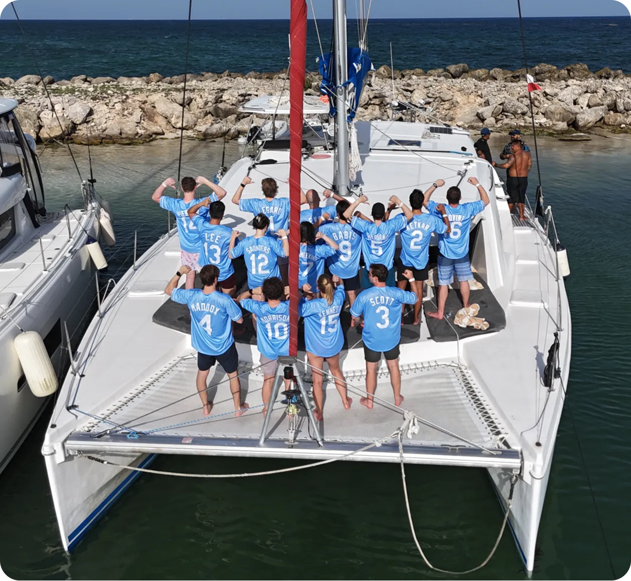 The Verisoul team wearing blue jerseys on the back of a catamaran at our 2026 offsite in Tulum, Mexico. The jersey numbers represent employee number.