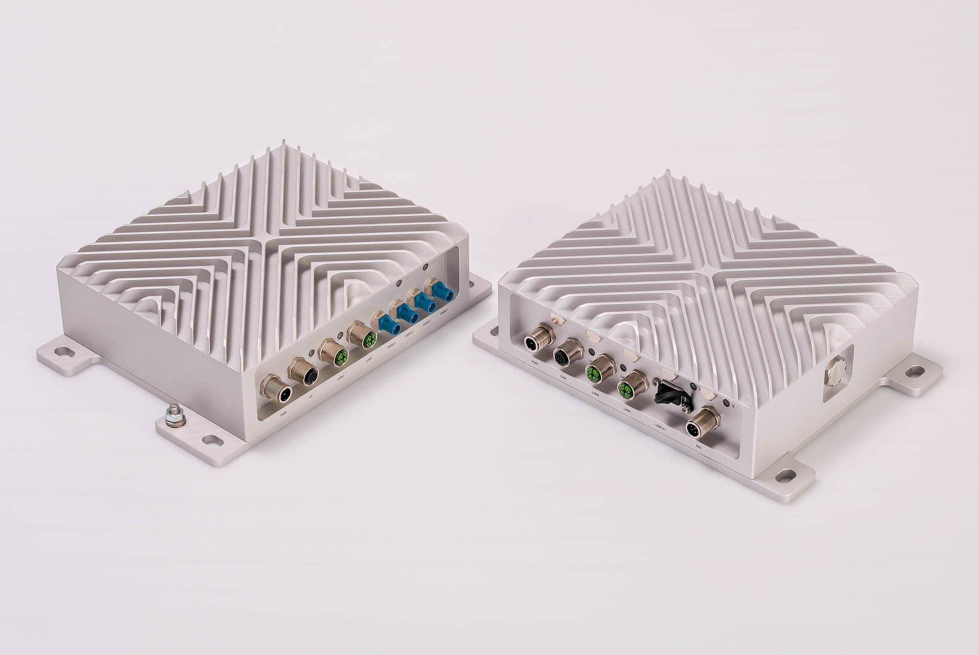Two ruggedized embedded computers by specialist Syslogic. Aluminum housing with cooling fins.