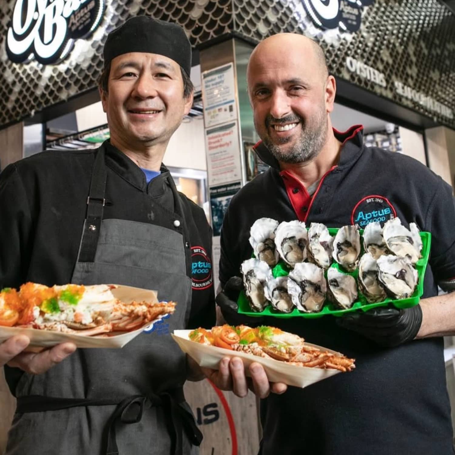 Aptus Seafood team holding fresh seafood produce