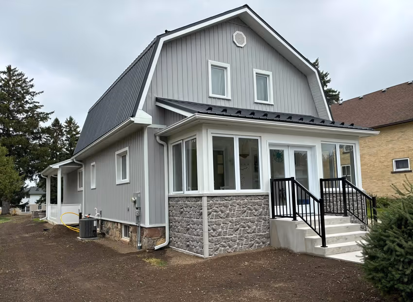 Photo of the renovated house featuring the porch with the stairs