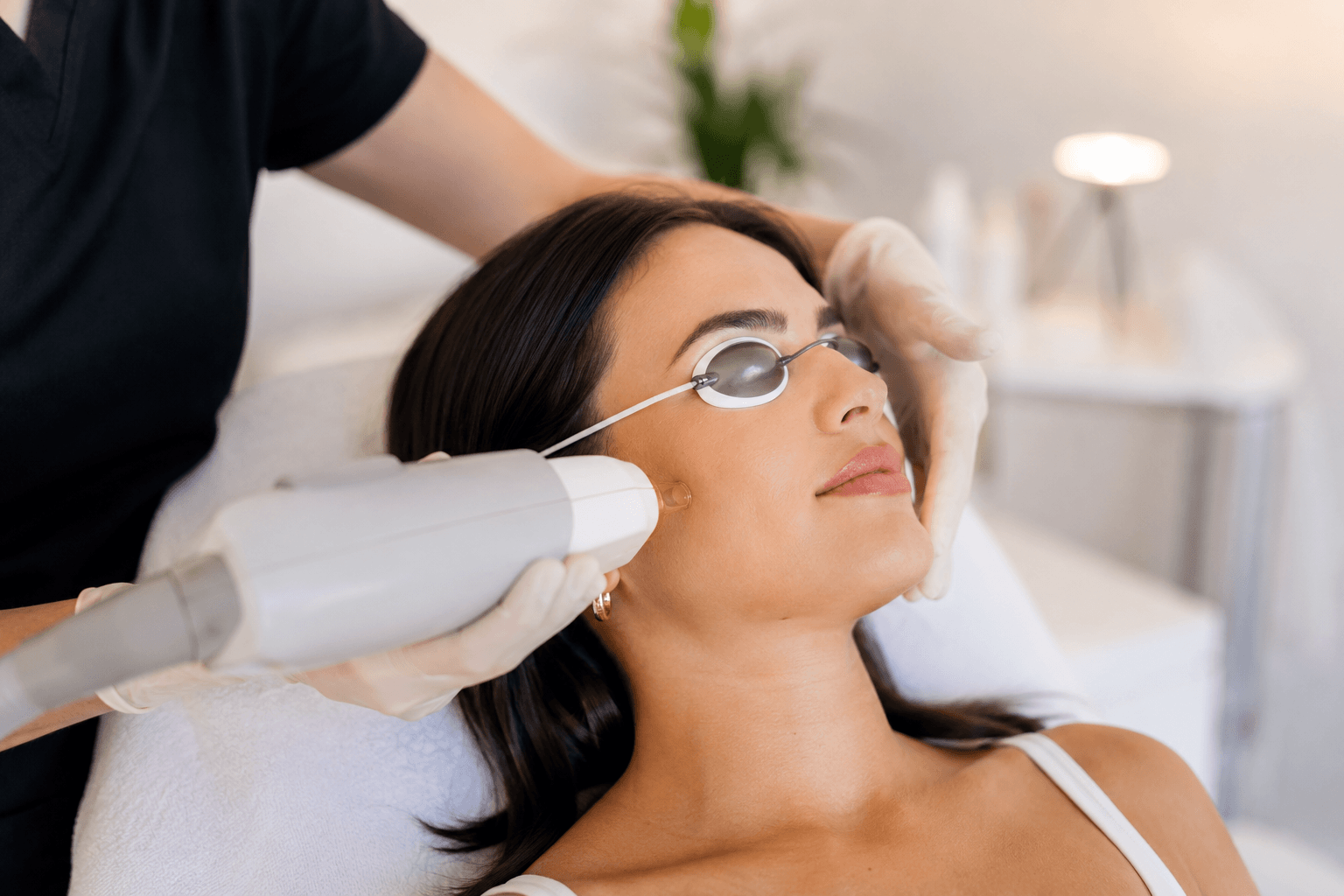 Woman receiving laser facial hair removal treatment in Rockwall, Texas med spa
