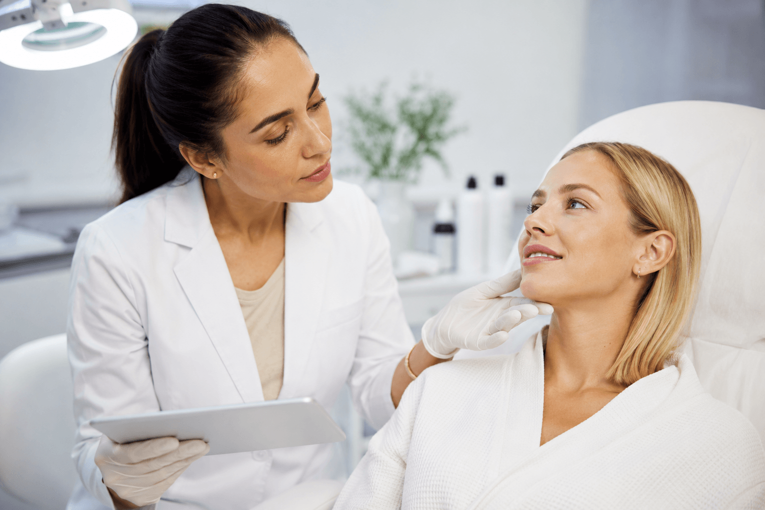 Provider evaluating patient for a chemical peel in Rockwall, Texas during a professional skin consultation