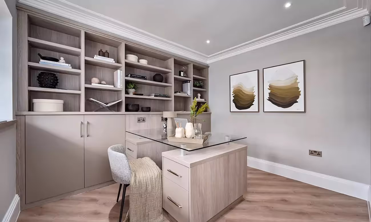 A modern bespoke home office with grey wooden office storage and glass table top desk