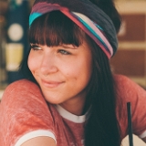girl with red t-shirt and dark hair and a hand band